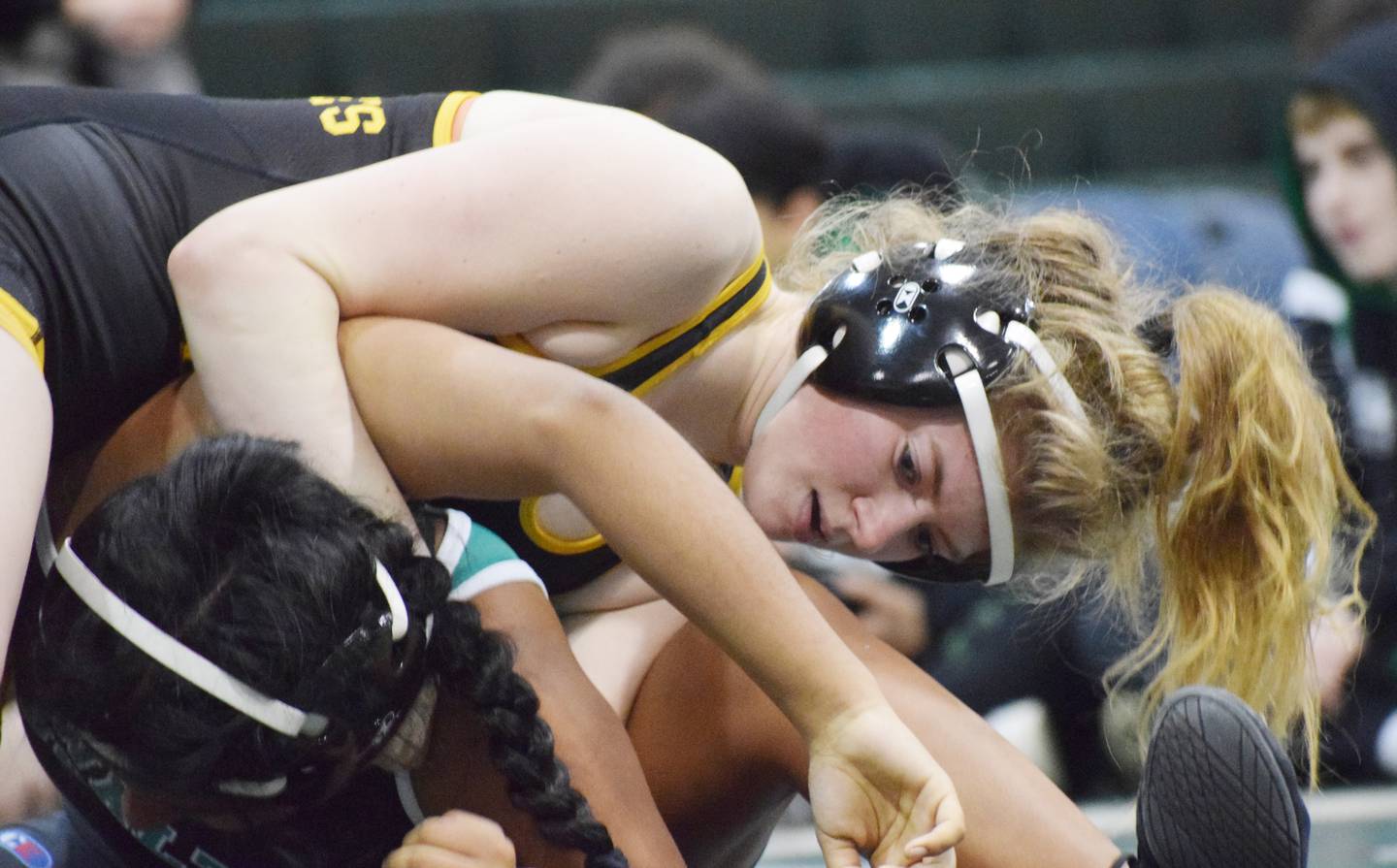 Queen Anne's junior captain Delaney Gray (top) pinned 130-pound rival Mia Magone of Walter Johnson of Montgomery County in 84 seconds.
