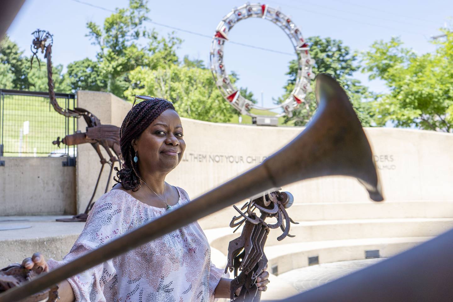 Jenenne Whitfield, the new director of the American Visionary Arts Museum, stands with a bird sculpture outside of the museum.