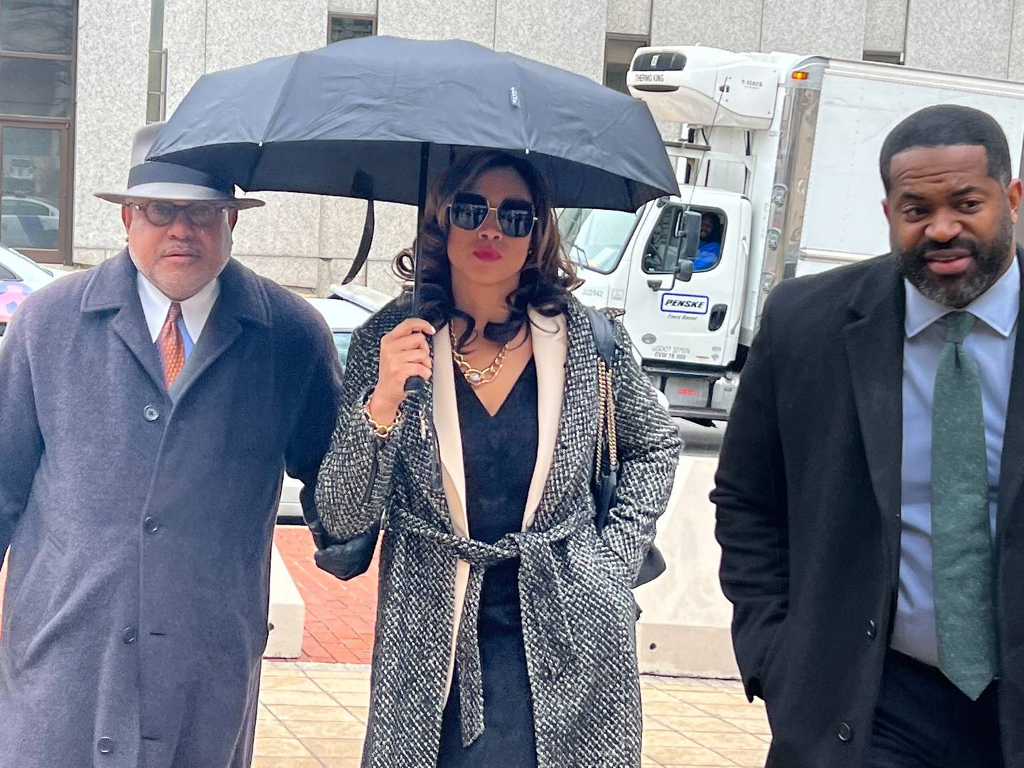 Former Baltimore State's Attorney Marilyn Mosby arrives in court flanked by her attorney, A. Scott Bolden, left, and husband, City Council President Nick Mosby.