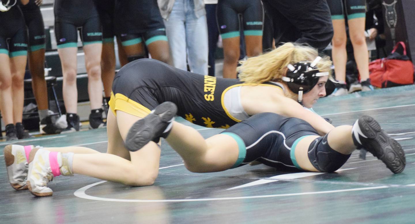 Queen Anne's junior captain Julia Reburn (top) pinned 135-pound rival Madeline Barnett of Walter Johnson of Montgomery County in 35 seconds.