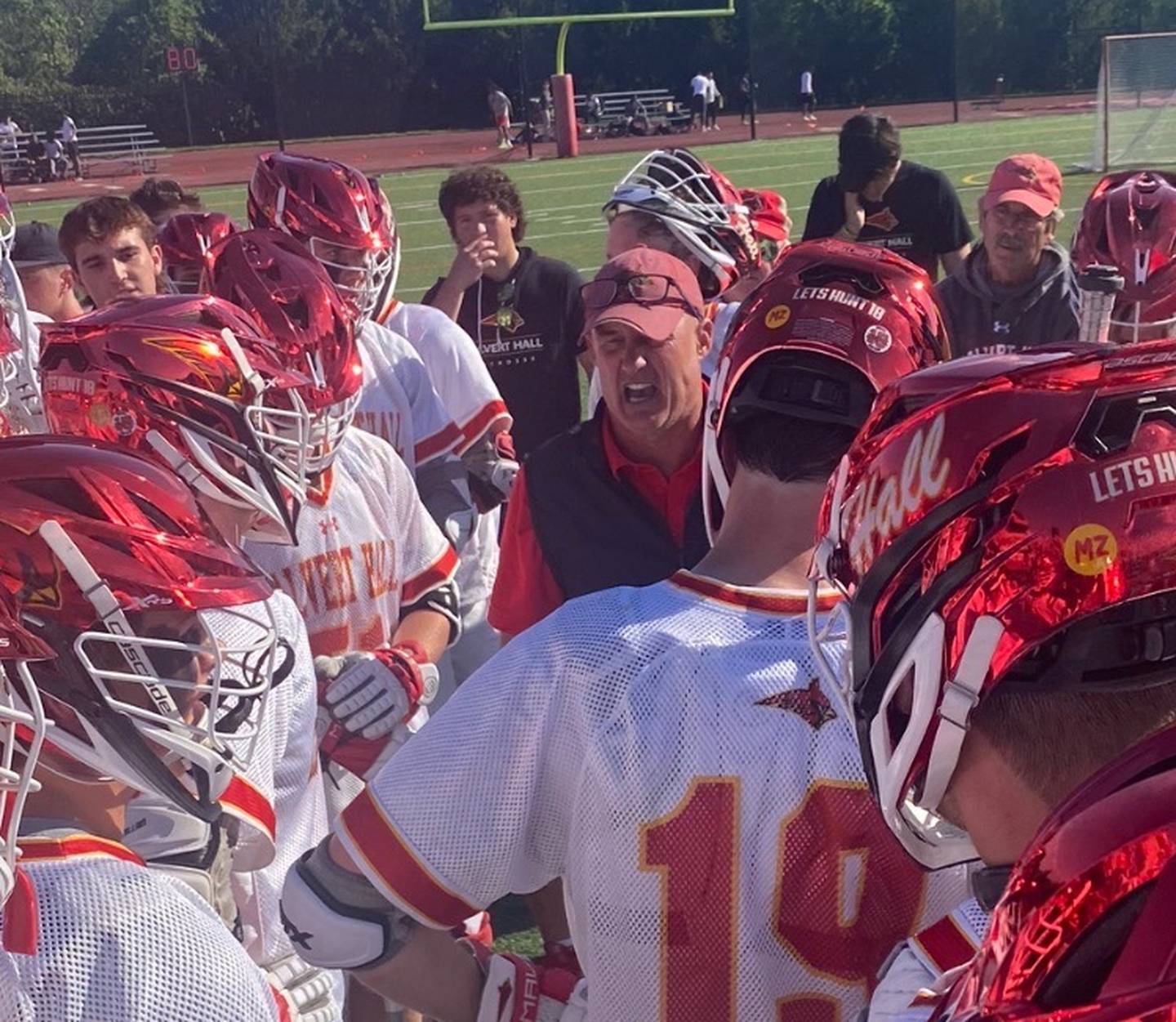 Calvert Hall lacrosse coach Bryan Kelly talks to his team during a timeout Tuesday. The No. 2 Cardinals gained the second-seed for the MIAA A Conference playoffs with a 6-5 victory over fifth-ranked Loyola in the regular season finale at Russo Stadium in Towson.