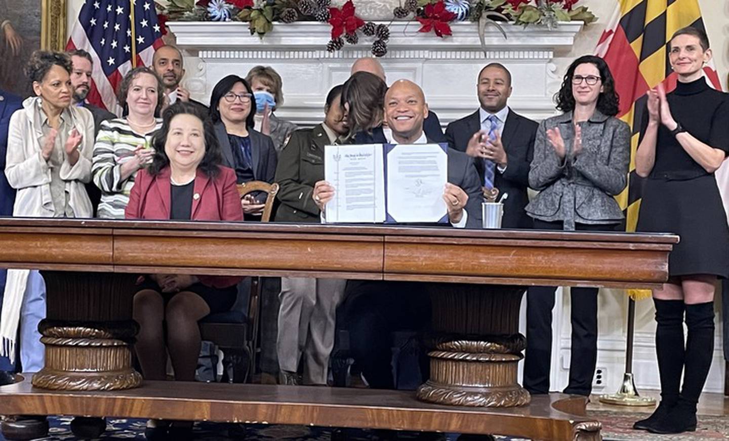 Maryland officials applaud as Gov. Wes Moore presents an executive order he signed Monday in the Maryland State House outlining the state's exploratory approach to artificial intelligence technologies.