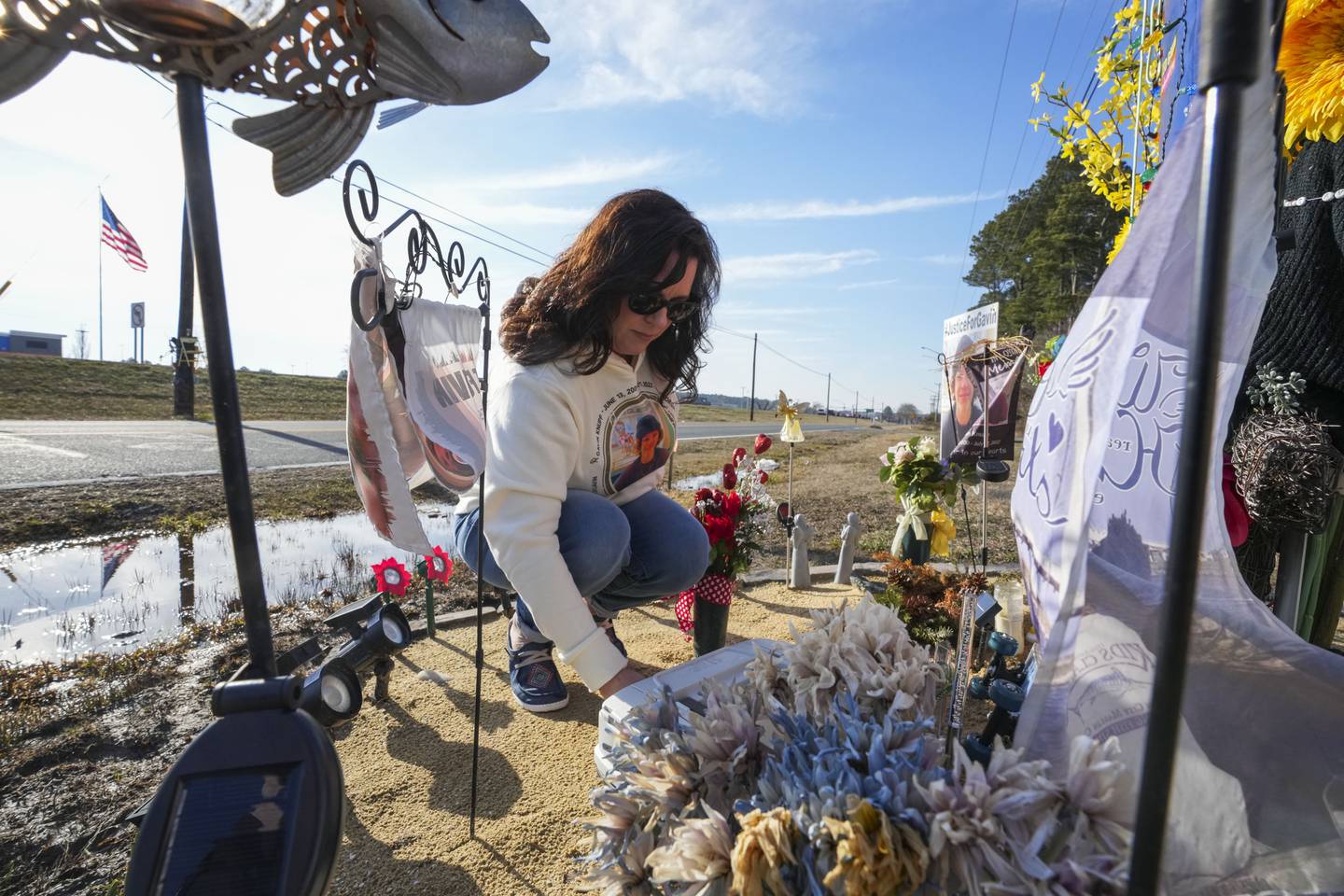 Gavin Knupp's mother, Tiffany Knupp, fixes and adds things to his memorial on the side of the service road where the hit-and-run took place last summer.