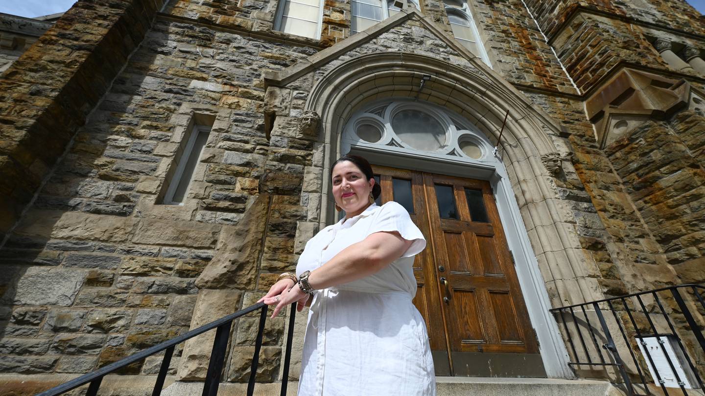 Cynthia Mendoza poses for a photograph in front of Our Lady of Good Counsel Catholic Church Wednesday, May 8, 2024 in Baltimore.