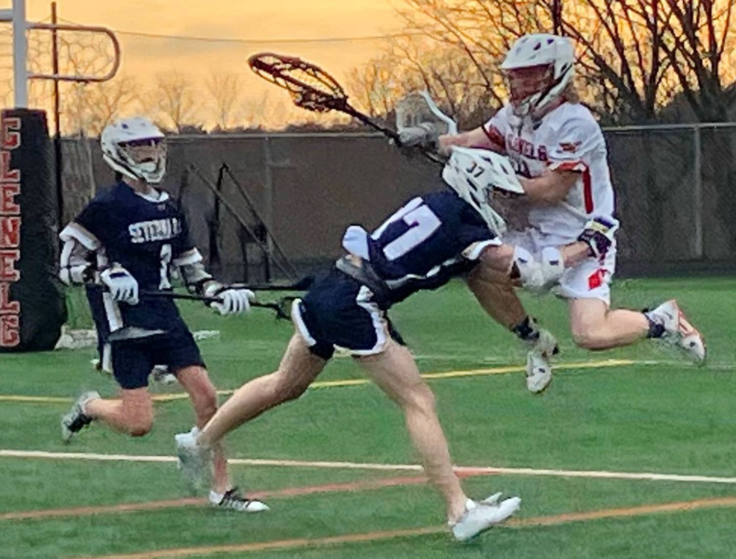Severna Park junior attackman Kenny Brazil shows what riding is all about as he checks Glenelg sophomore goalie Zach Coughlin while Falcon sophomore midfielder Jack Fish arrives on the scene. No. 9 Severna Park won the inter-county battle, 11-3, over the Gladiators.