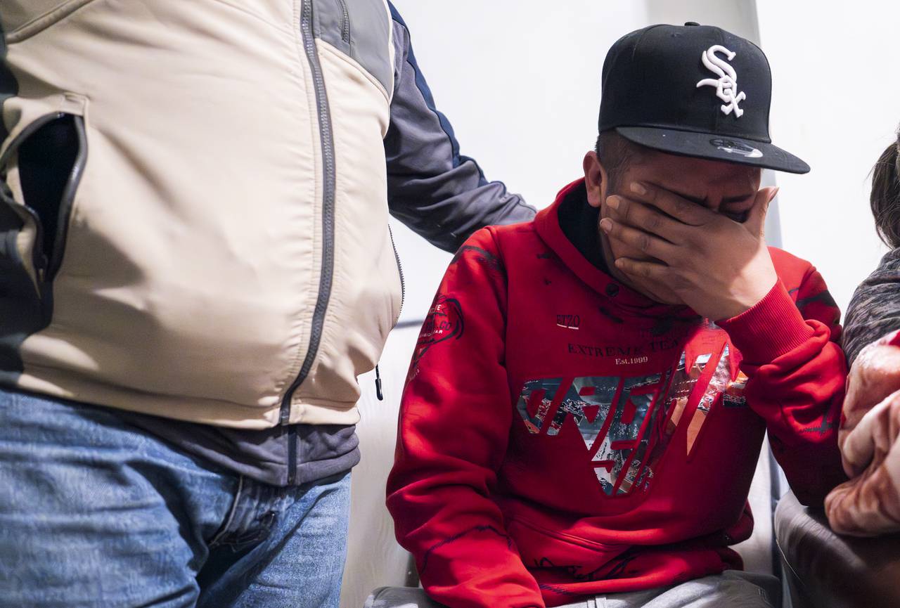 Elida Gutierrez Gomez's brother Hector, 23, sobs as Gomez tells stories about her children and nephew.