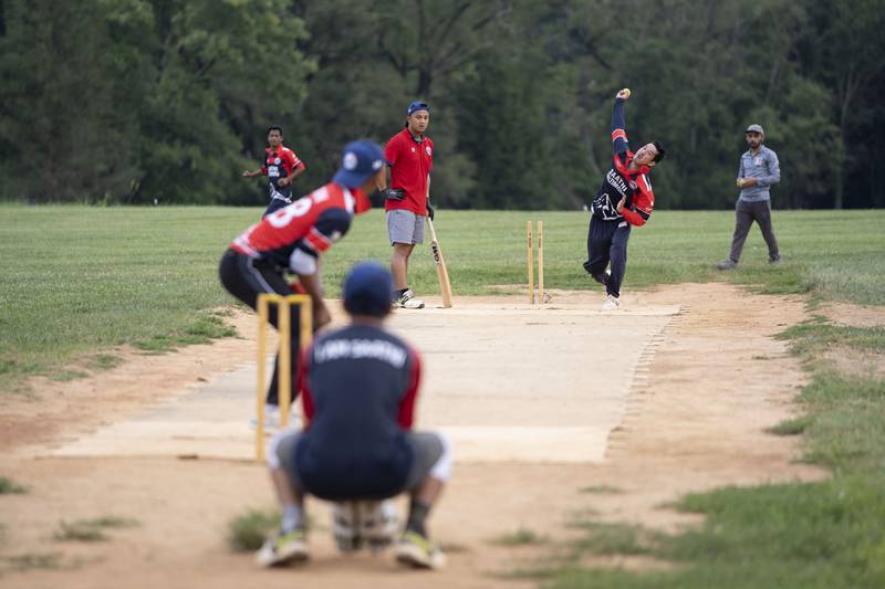 Team Captain Rupesh Thapa bowls the ball at cricket practice July 27. Two team members alternate bowling to the batter.