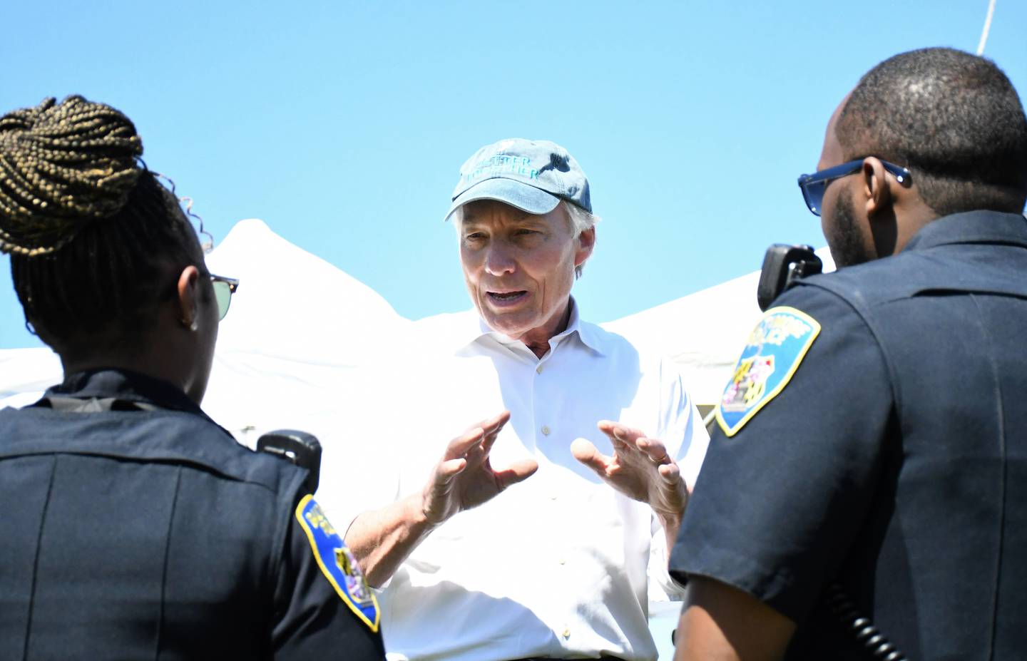 Peter Franchot, the state comptroller who is running for governor as a Democrat, talks with Baltimore City police officers during the AFRAM festival at Druid Hill Park on Sunday, June 19, 2022. Franchot gave them commemorative medallions from his office, as he often does when he meets people with backgrounds in law enforcement or military service.