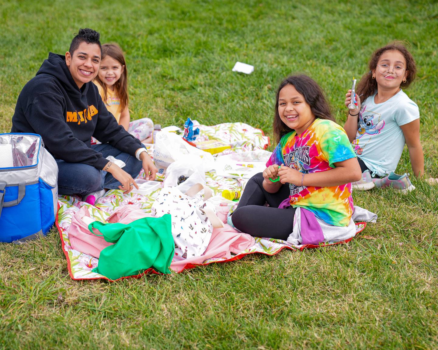A young family takes a break from the Harbor Harvest Festival to enjoy a picnic. The festival will coincide with the one-year anniversary of the opening of Rash Field Park.