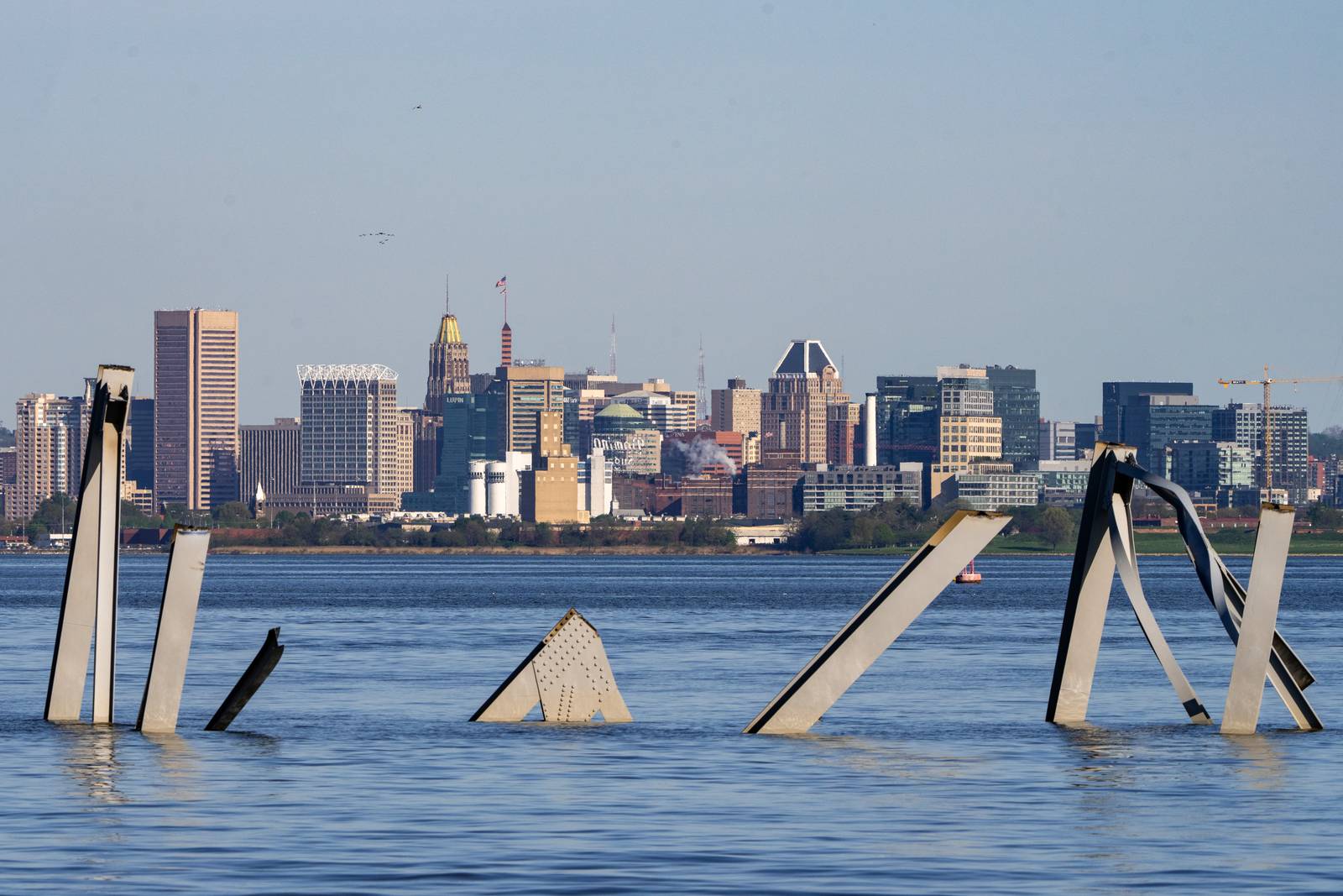 The Baltimore skyline is seen behind wreckage from the Key Bridge collapse on Tuesday, April 16, 2024.
