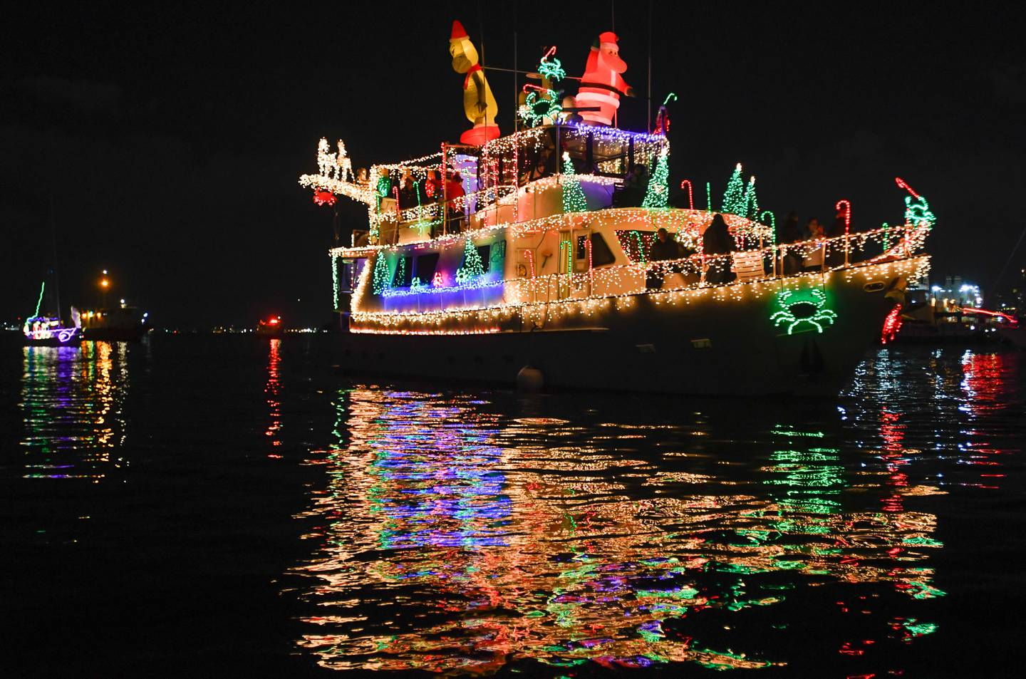 The Baltimore Lighted Boat Parade moves past Canton, Saturday, Dec. 3, 2022.