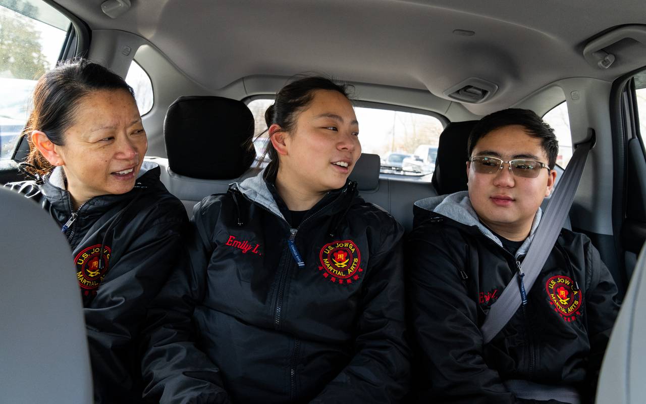 From left, Winnie, Emily and Eric Lam chat while on the way to a performance on Saturday, Feb. 17, 2024.