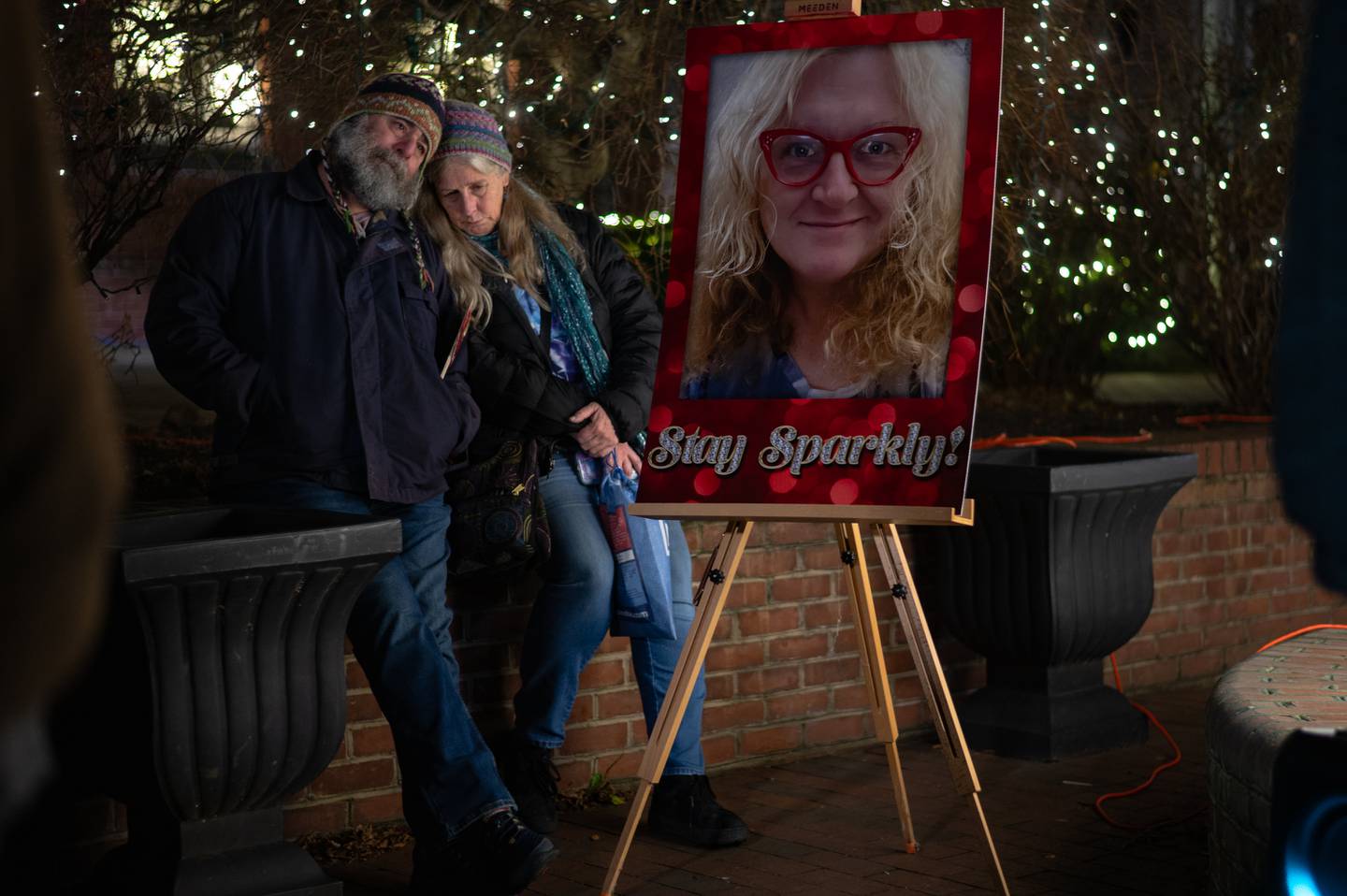 Kathy Helley and Hoe Solow sit by a photograph honoring Meghan Lewis in Bel Air, MD on Jan 2, 2024.