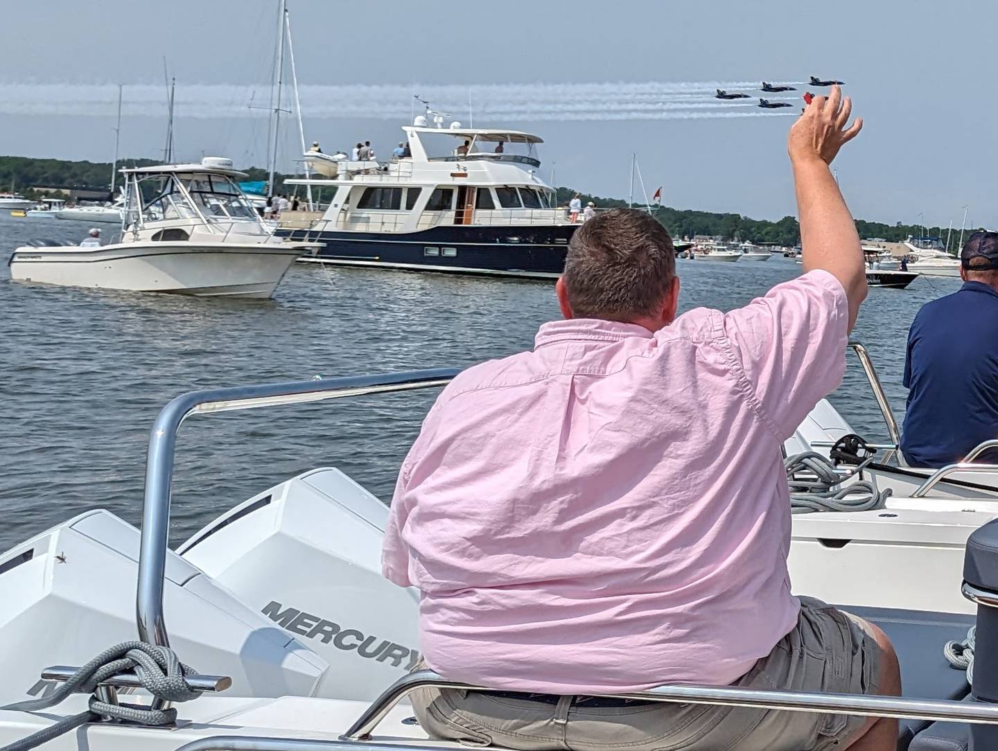A spectator waves at the Blue Angels as they fly over the Severn River Wednesday in Annapolis.