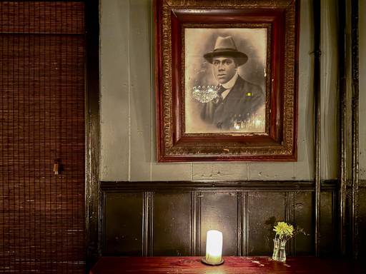 The decor of WC Harlan's is old photographs, candles melting candle wax, dimly lit, and cozy.