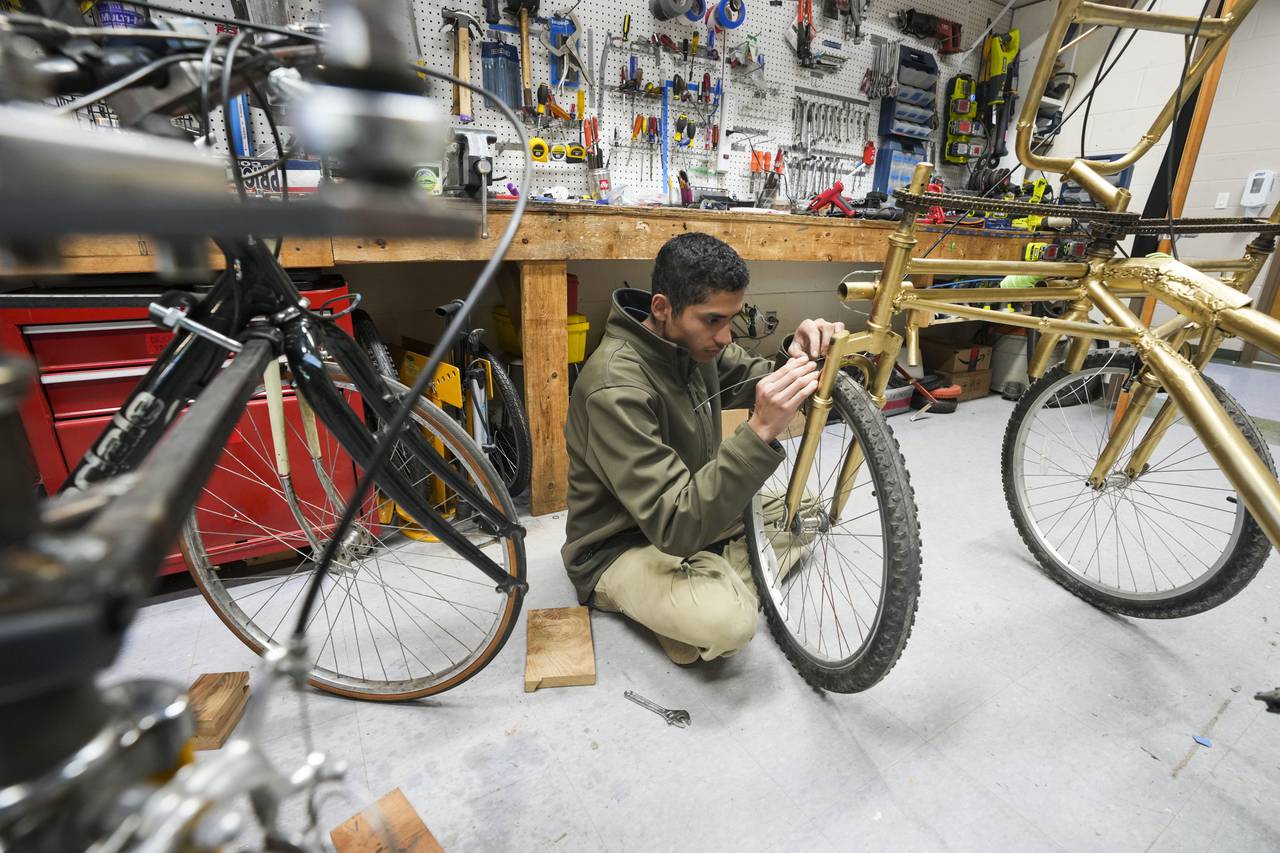 Jonathan Kuessner works on a bike that he will be piloting during the race.