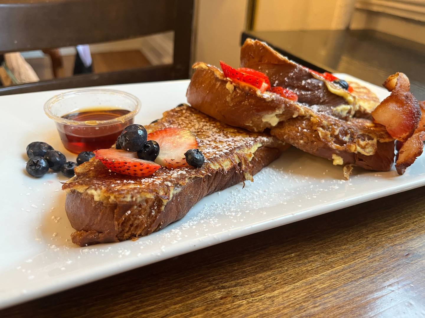 Farm Bell Kitchen in Charlottesville, Virginia serves brioche French toast with maple syrup and berries.