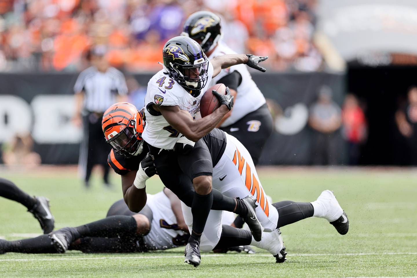 CINCINNATI, OHIO - SEPTEMBER 17: Justice Hill #43 of the Baltimore Ravens is tackled by Zach Carter #95 of the Cincinnati Bengals during the fourth quarter at Paycor Stadium on September 17, 2023 in Cincinnati, Ohio. (Photo by Andy Lyons/Getty Images)