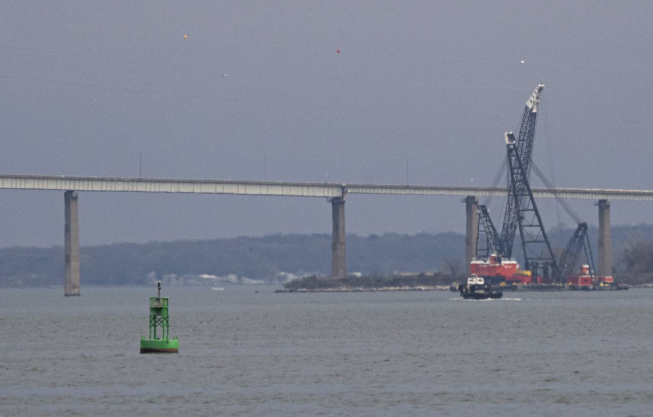 A crane arrives to begin clean up of the collapse of the Key Bridge on March 30, 2024
