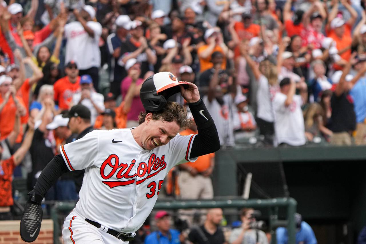 Baltimore Orioles catcher Adley Rutschman (35) cheers after scoring on center fielder Cedric Mullins’ sacrifice fly in the eleventh inning to win the game against the Tampa Bay Rays on Sunday, September 17, 2023. The Baltimore Orioles clinched a spot in the postseason for the first time since 2016.