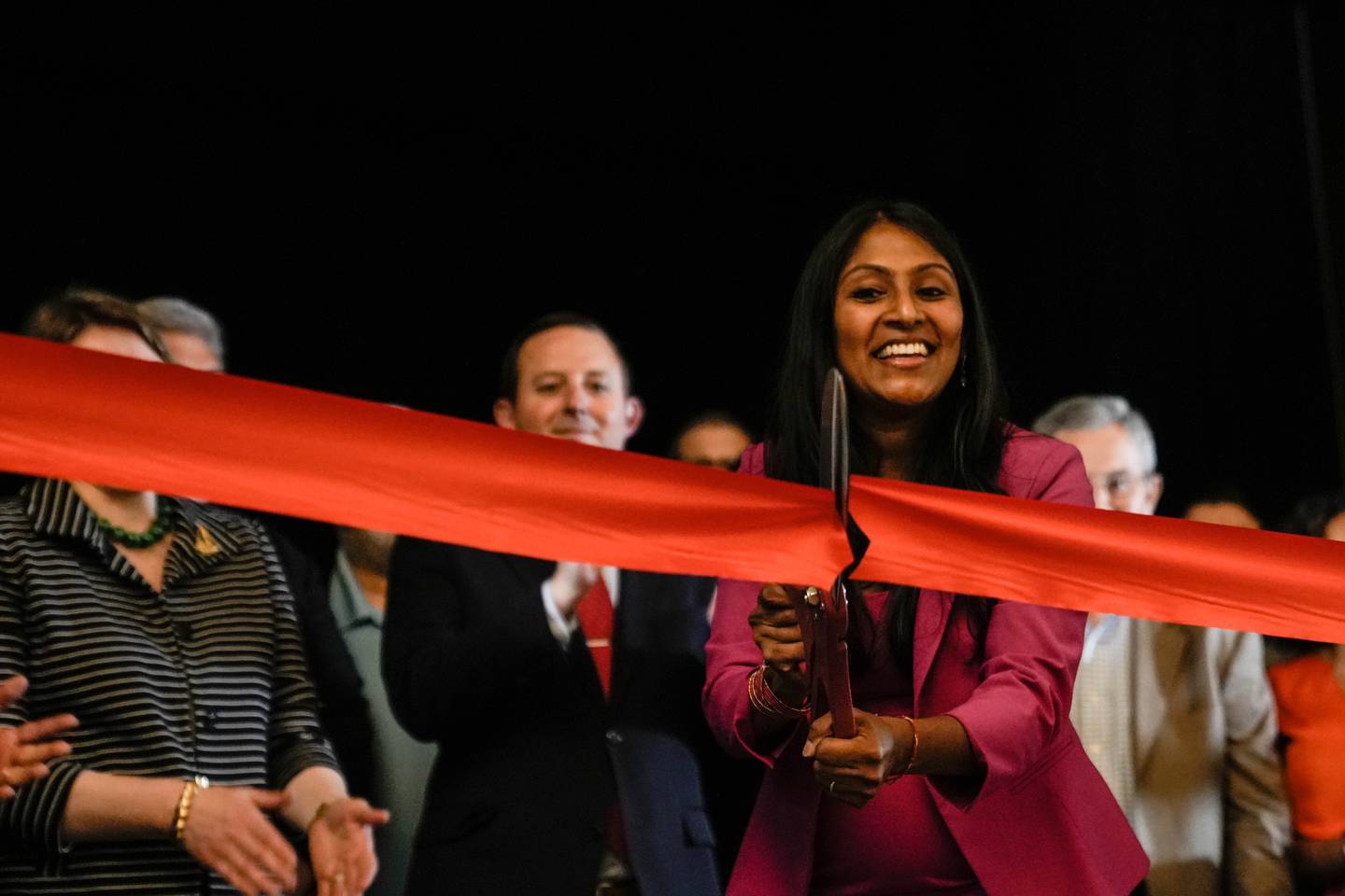 Krish O'Mara Vignarajah, President and CEO of the Lutheran Immigration and Refugee Service, cuts the ribbon at their opening ceremony.