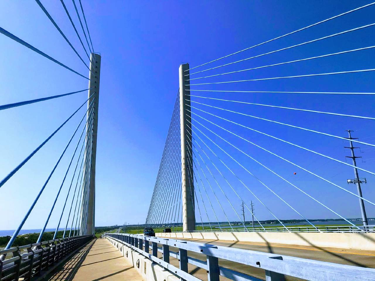 The Charles W Cullen Bridge near Bethany Beach, Delaware, is a cable swayed bridge over the Indian River Inlet that includes paths for walking and biking as well as cars and trucks.