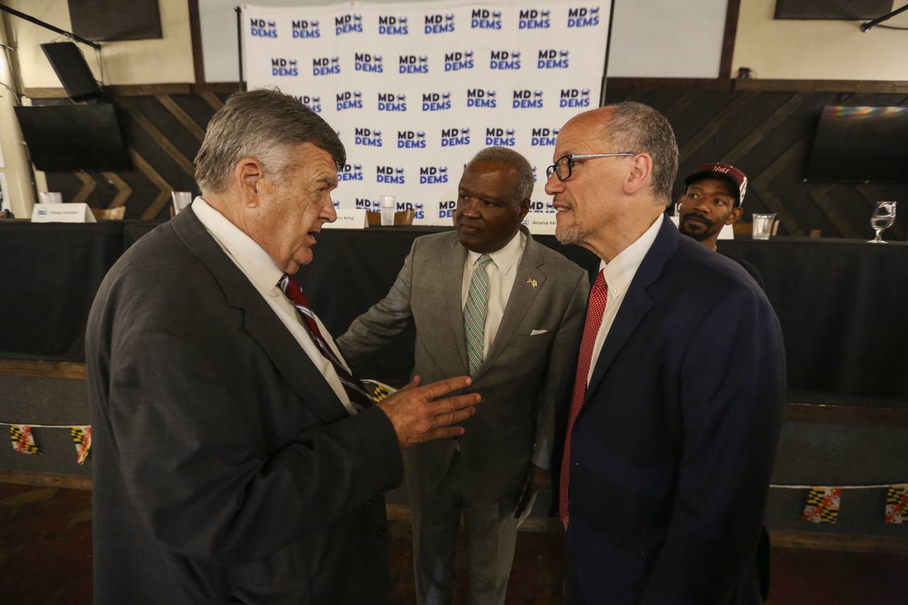 U.S. Rep. C.A. Dutch Ruppersberger, left, speaks with gubernatorial candidates Tom Perez, right, and Rushern L. Baker III, center, before a candidates forum on healthcare issues sponsored by the Maryland Democratic Party at BC Brewery on May 31, 2022. (Kaitlin Newman for The Baltimore Banner)