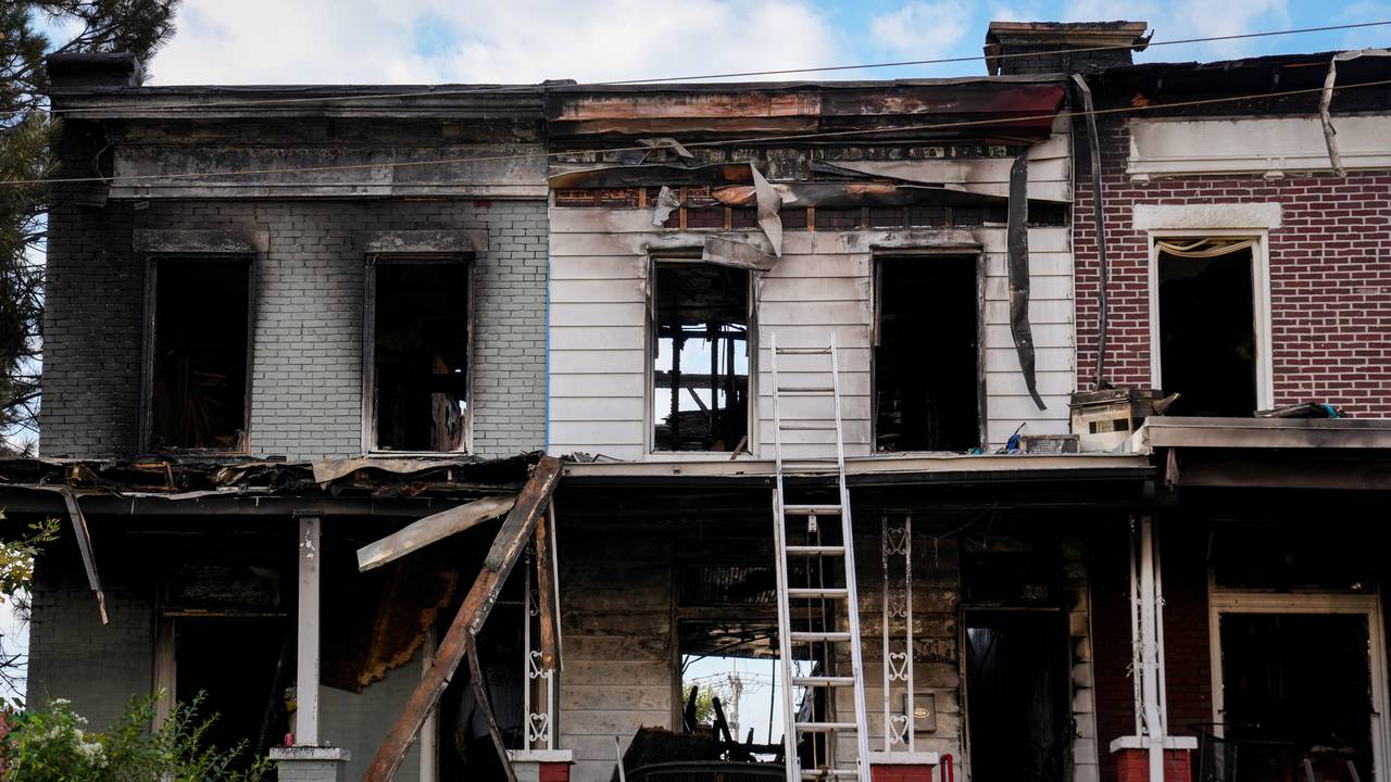 Baltimore City Fire Department and ATF officials examine multiple burned rowhomes in the 5200 block of Linden Heights Ave. on Friday, October 20, 2023. The fatal fire the previous night took the life of two firefighters and injured multiple others.