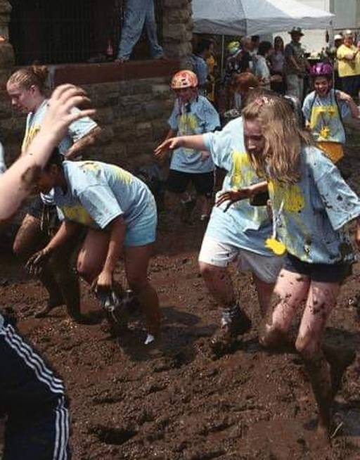 The Catholic Community team of Daley the Duck pushes through the mud, losing shoes and socks. The author, Kaitlin Newman, is to the right of the frame. (photo courtesy of Ian Macdonald via the KSR, May 2003)