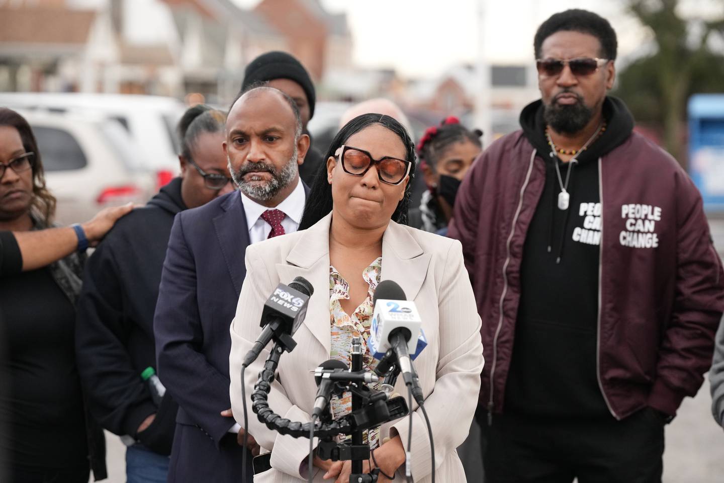 Family and friends of 16-year-old Edmondson, Dennta Dorsey who was the student killed yesterday, and Attorney Thiur Vignarajah (left) during a press conference at the Edmondson Village, site of the shooting.