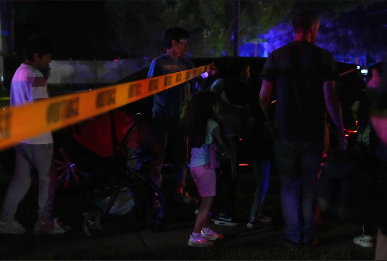 People gather at the scene of a shooting on Paddington Place in Annapolis on Sunday night, June 11, 2023. The daylight shooting at a single-family home left 1 dead and three injured.