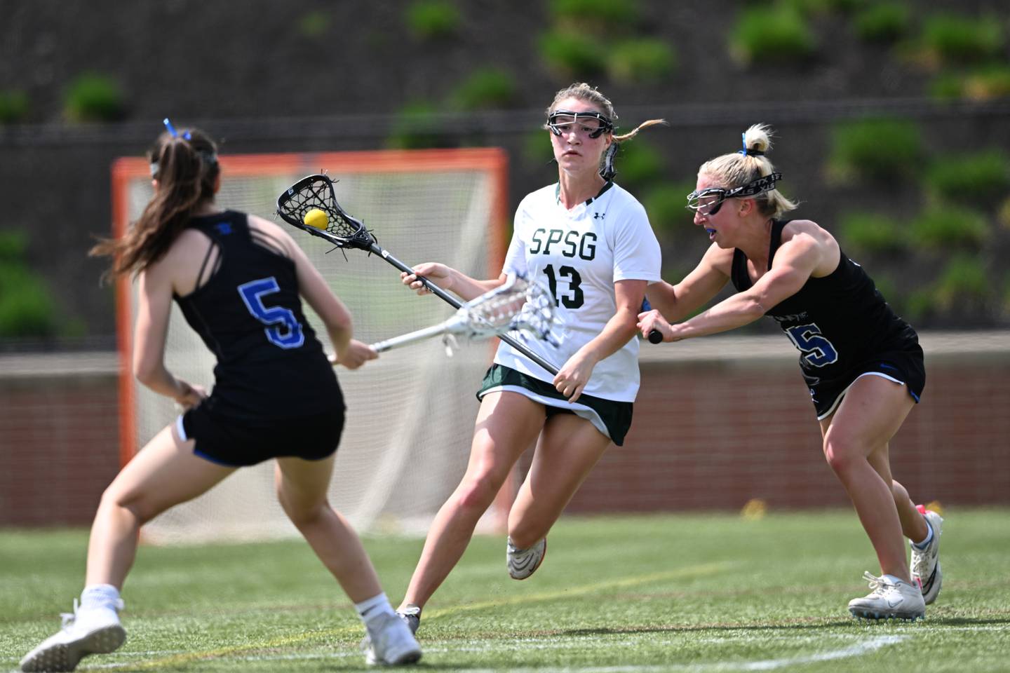 St. Pauls’ Natalie Shurheff charges between Darien’s Maggie Bellissiomo (5) and Kaci Benoit in the first half of a lacrosse game Saturday, April 15, 2023, in Sparks Glencoe, MD.
