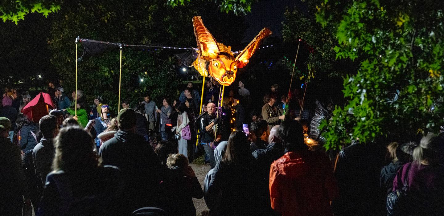 A bat soars over the crowd at The Great Halloween Lantern Parade at Patterson Park on Saturday, Oct. 21, 2023.