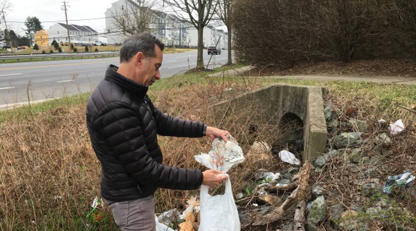 Rob Frier with the Baltimore County Sierra Club picks up plastic bags along Reisterstown Road in Owings Mills.