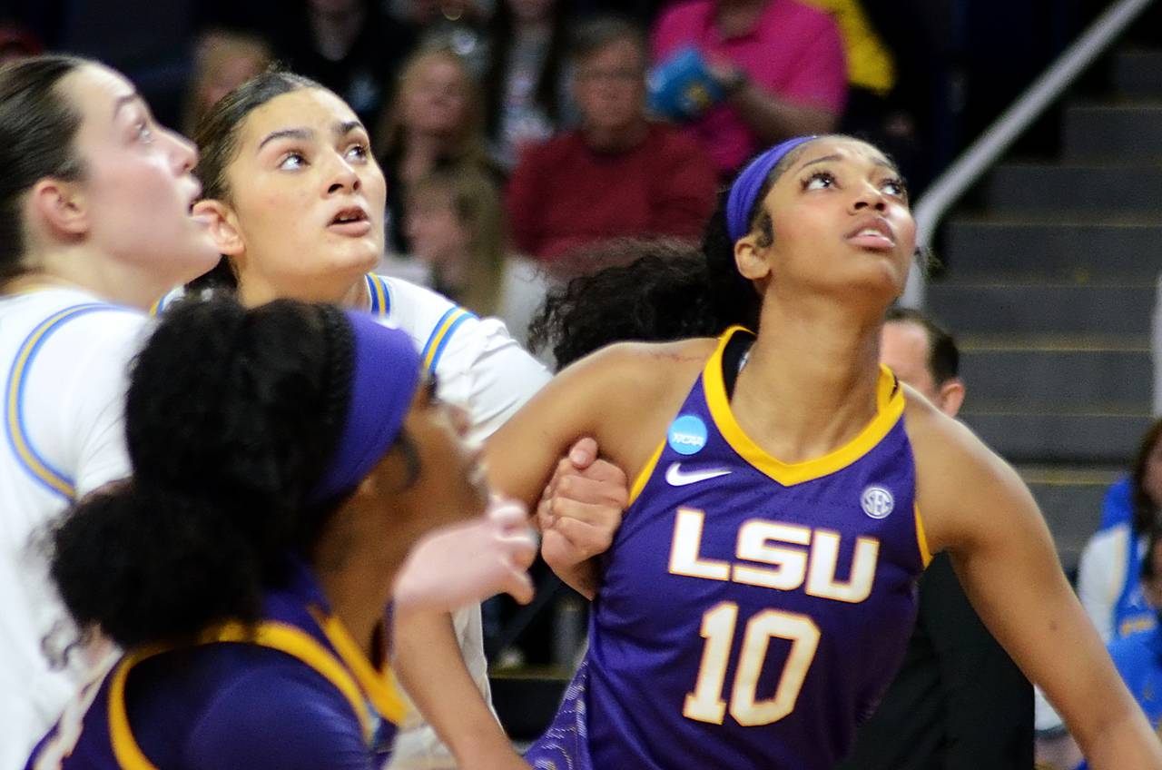 Angel Reese of LSU vies for rebounding position against two UCLA players during the Tigers' win over the Bruins in the third round of the NCAA tournament March 30, 2024, in Albany, New York.