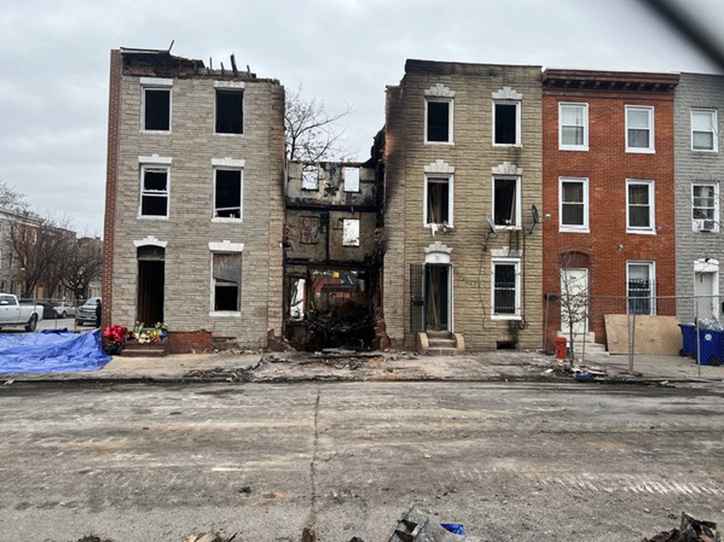 A gap between homes in the 200 block of S. Stricker St. marks the spot where a vacant home burned and collapsed, killing three Baltimore firefighters.