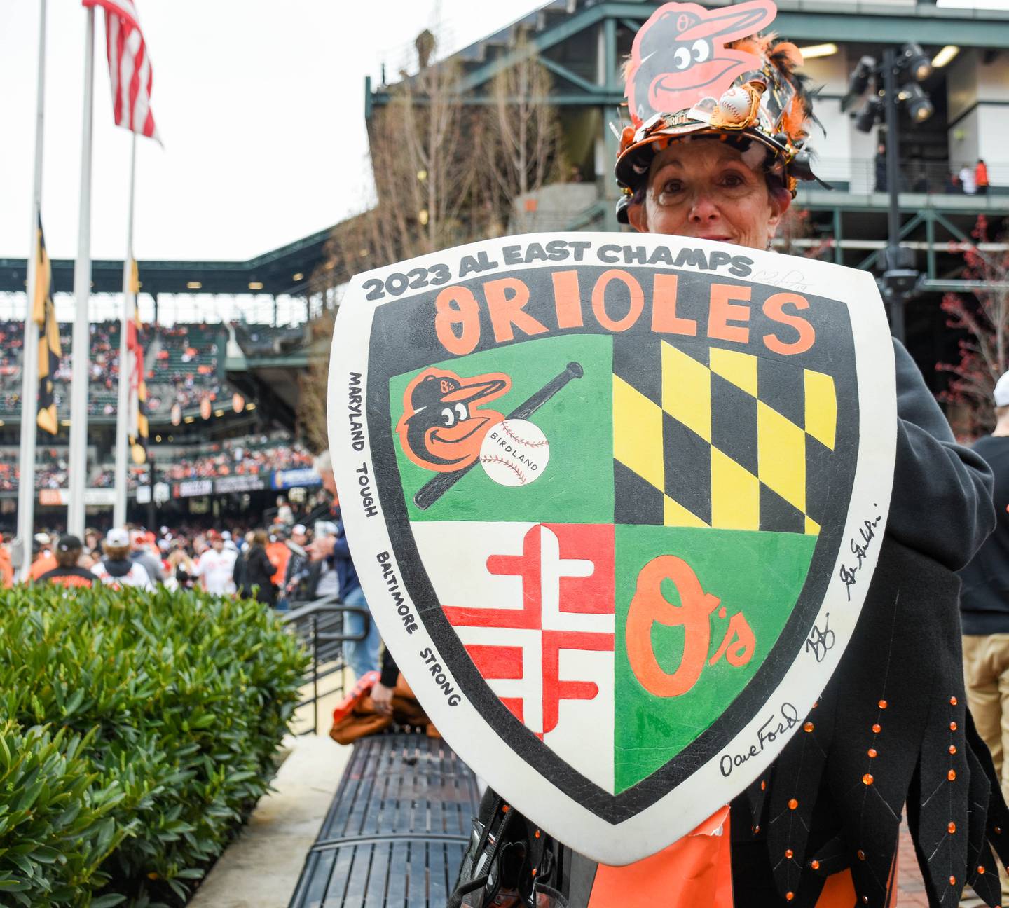 Orioles fan Robin Goodwin shows off her homemade shield with the words "Maryland Tough; Baltimore Strong" written on the side.