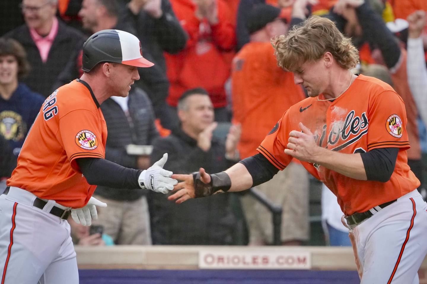 Jordan Westburg and Gunnar Henderson celebrate after scoring a run against the Texas Rangers in Game 2 of the ALDS at Camden Yards.