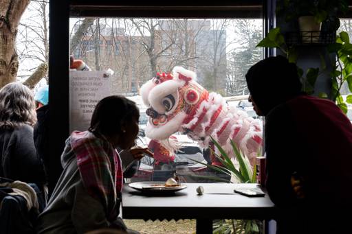 Customers at Café Columbia react in awe during a lion dance performance on Saturday, Feb. 17, 2024.
