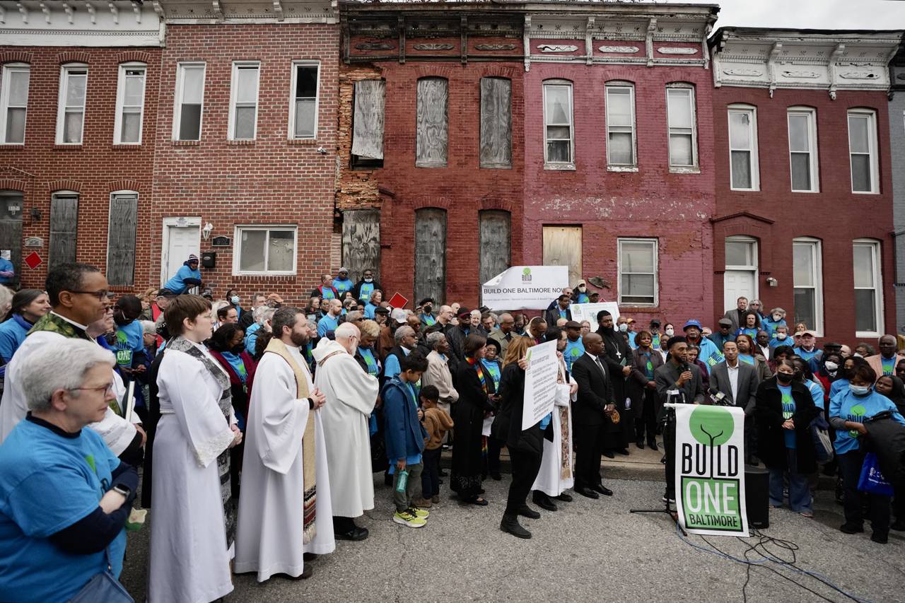 Mayor Brandon Scott speaks outside of vacant homes on West Saratoga street during a press conference hosted by Build One Baltimore on February 16, 2023.