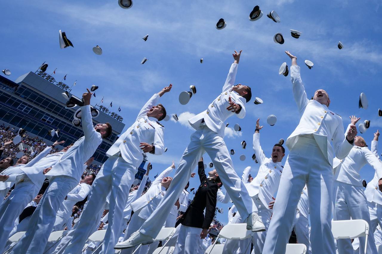 Graduating midshipmen toss their covers into the sky at the conclusion of the U.S. Naval Academy’s graduation ceremony at the Navy-Marine Corps Memorial Stadium on May 26, 2023. The graduating midshipmen are commissioned as either an ensign in the U.S. Navy or a 2nd Lieutenant in the U.S. Marine Corps.