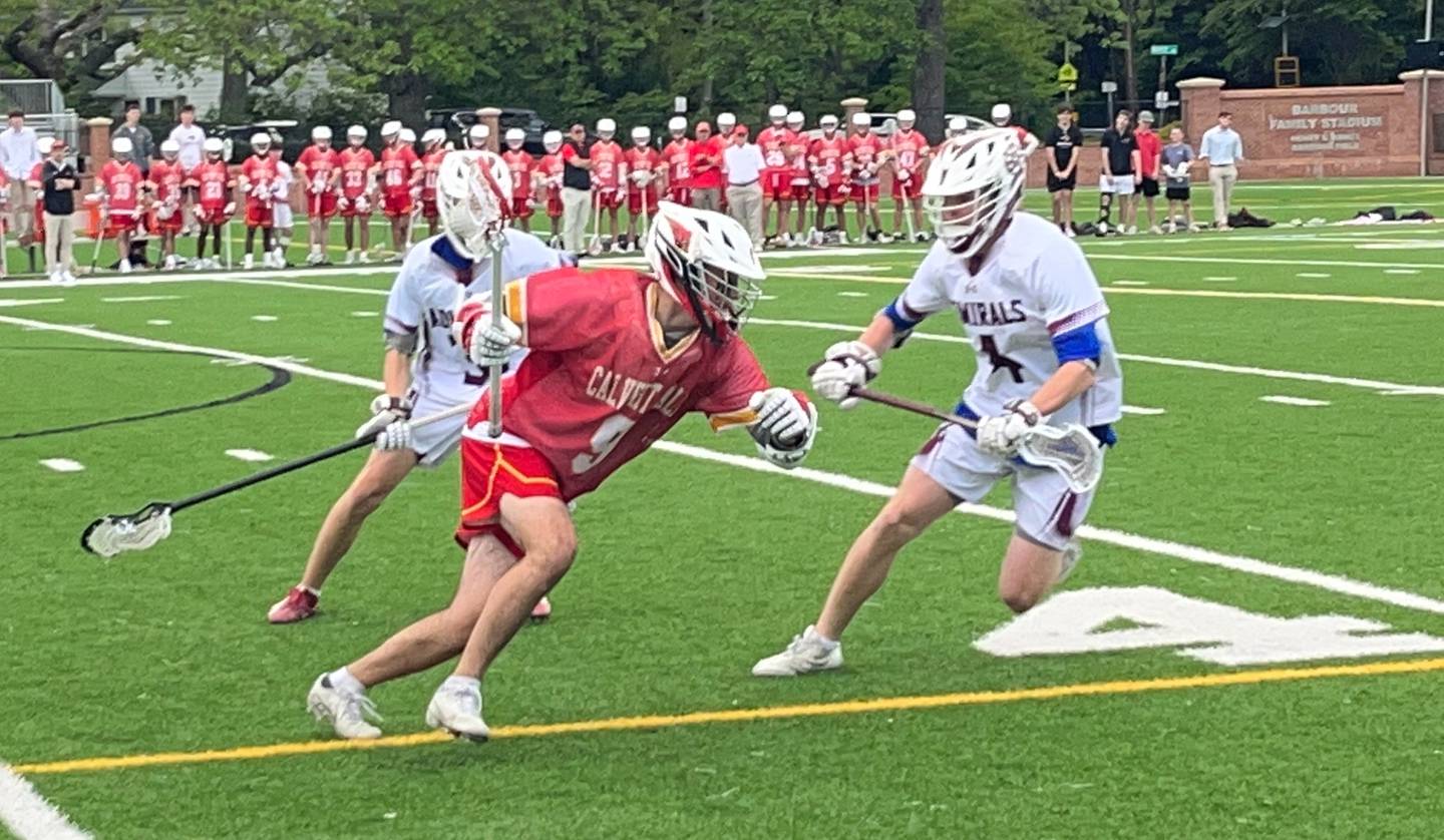 Calvert Hall's Shuey Kelly (9) tries to get past Severn's Fionn Kinsella during Friday's MIAA A Conference lacrosse contest. Kelly finished with four goals and an assist as the No. 2 Cardinals scored eight goals in the second half for a 10-6 victory over the No. 10 Admirals in Severna Park.