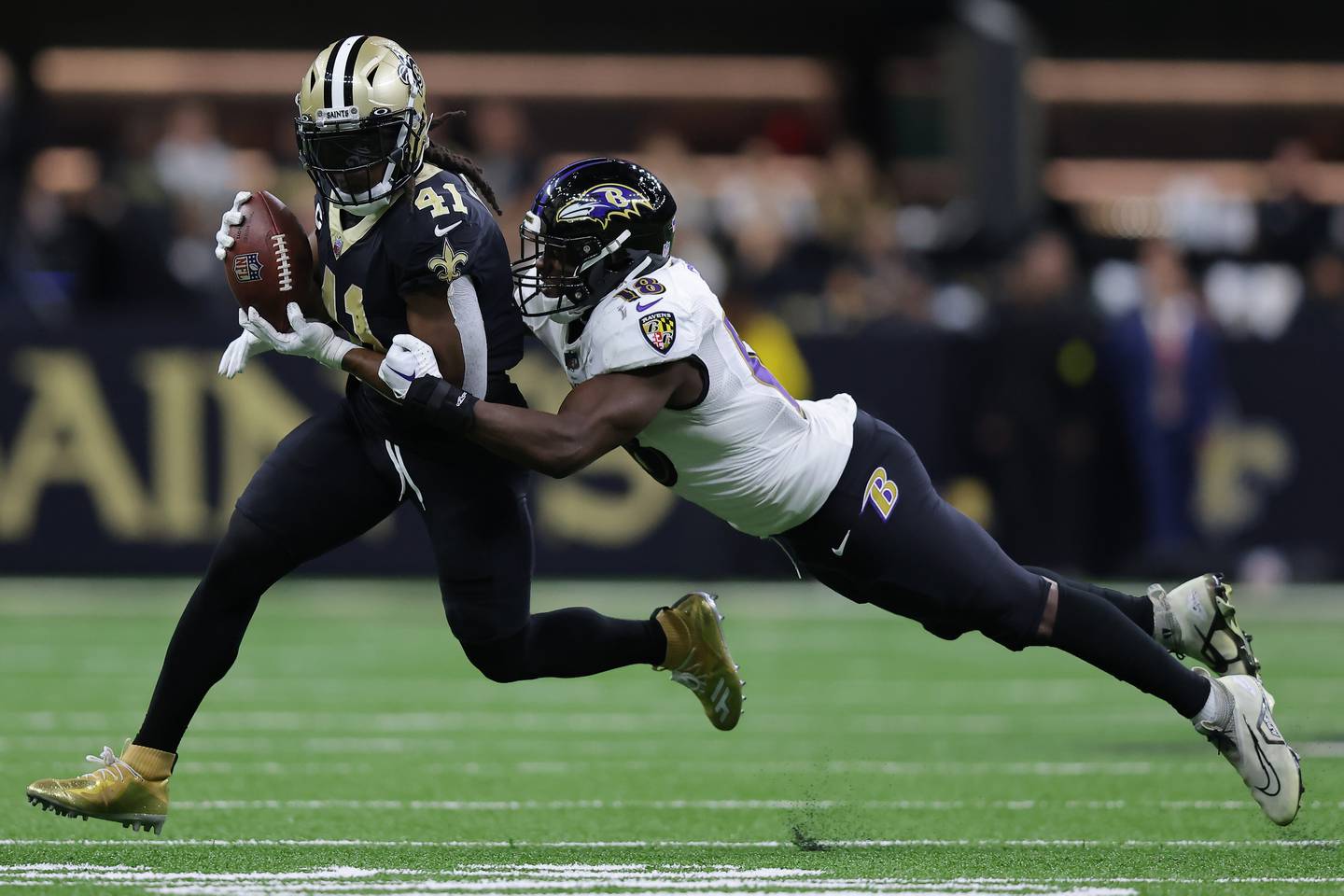 NEW ORLEANS, LOUISIANA - NOVEMBER 07: Alvin Kamara of the New Orleans Saints is tackled by Roquan Smith of the Baltimore Ravens during the second quarter at Caesars Superdome on November 07, 2022 in New Orleans, Louisiana.