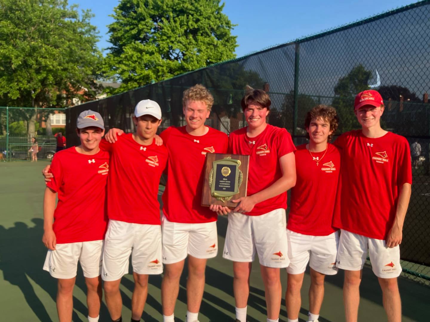 The Calvert Hall tennis team shows off its MIAA A Conference championship plaque after defeating perennial league power Gilman, 3-2, in Thursday's league championship match.