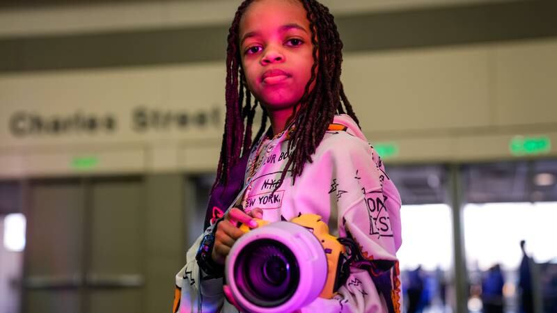 Myles Minishotta, a young photographer who has been covering the CIAA tournament this year, poses for a portrait at Fan Fest in the Baltimore Convention Center on Friday, March 1, 2024.