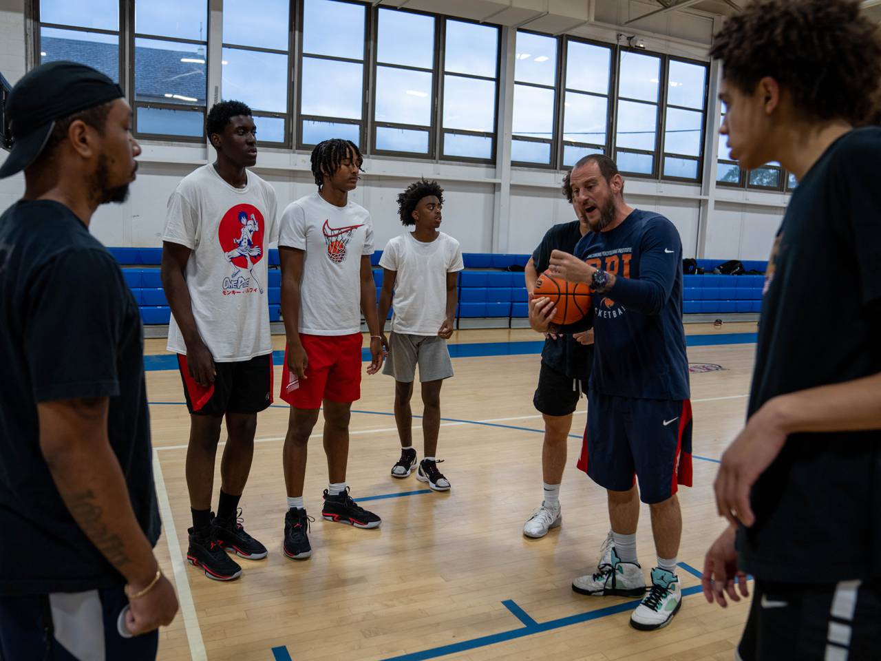 Coach Sam Brand working with the Team Melo AAU basketball team, including Malik Washington.