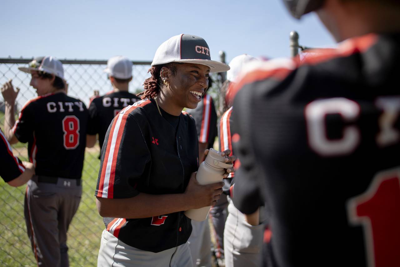 Rocksann Smith (No. 2) of the Baltimore City College Knights Varsity Baseball Team laughs along with her teammates during their game against Dunbar on 4/26/2024 in Baltimore, MD.