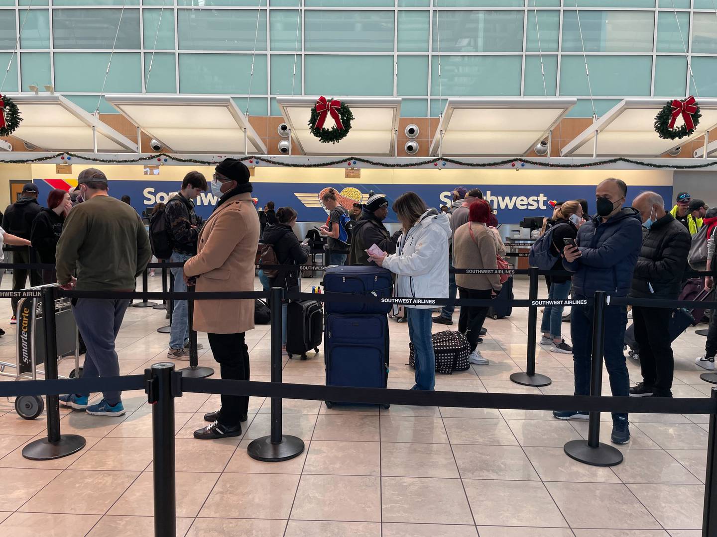 Southwest Airlines travelers stand in a long line at Baltimore/Washington International Airport after thousands of flights were canceled over the holiday weekend.