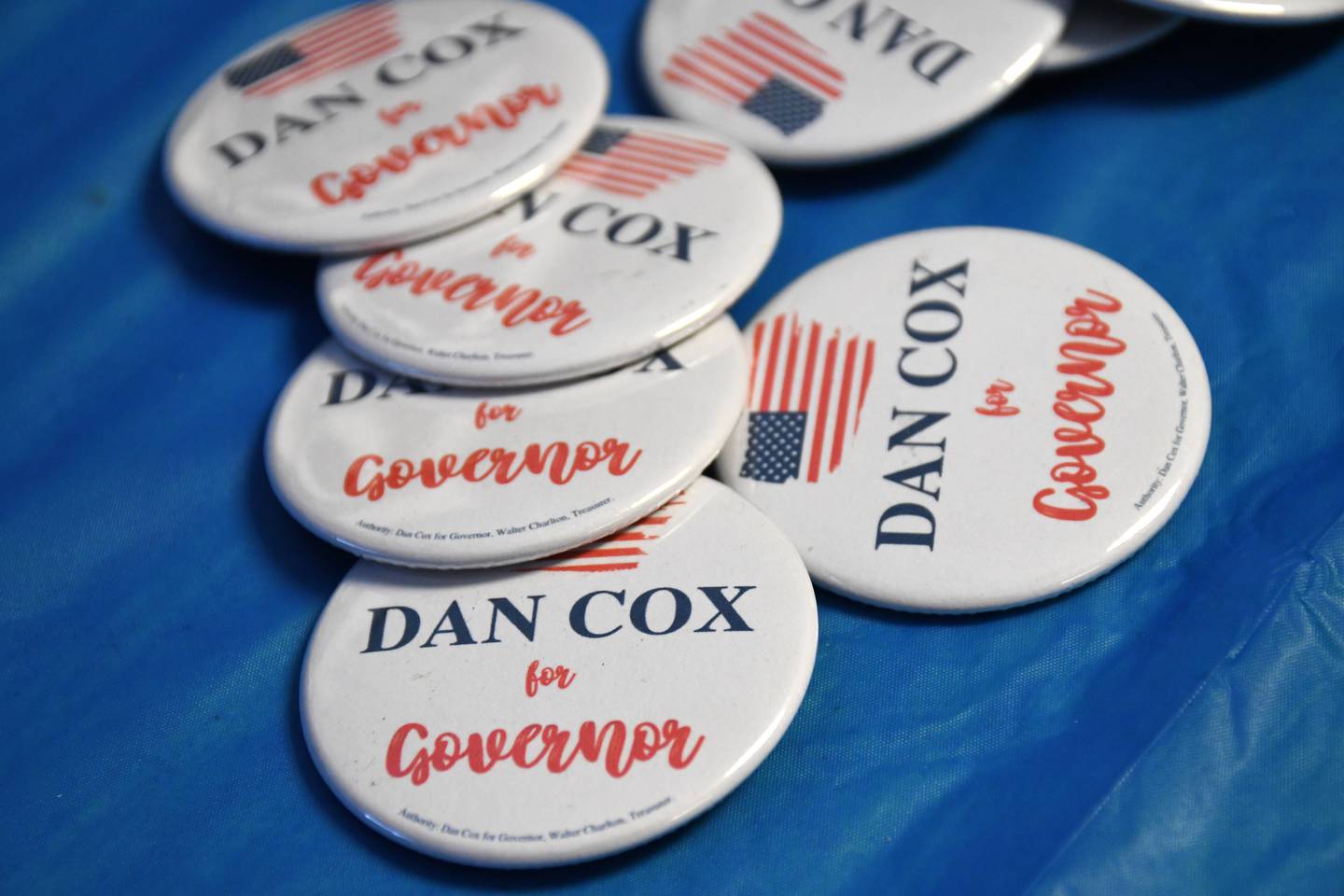 Campaign buttons are set out on a table at a campaign office opening for Dan Cox, the Republican nominee for Maryland governor, in Annapolis on Aug. 15, 2022.