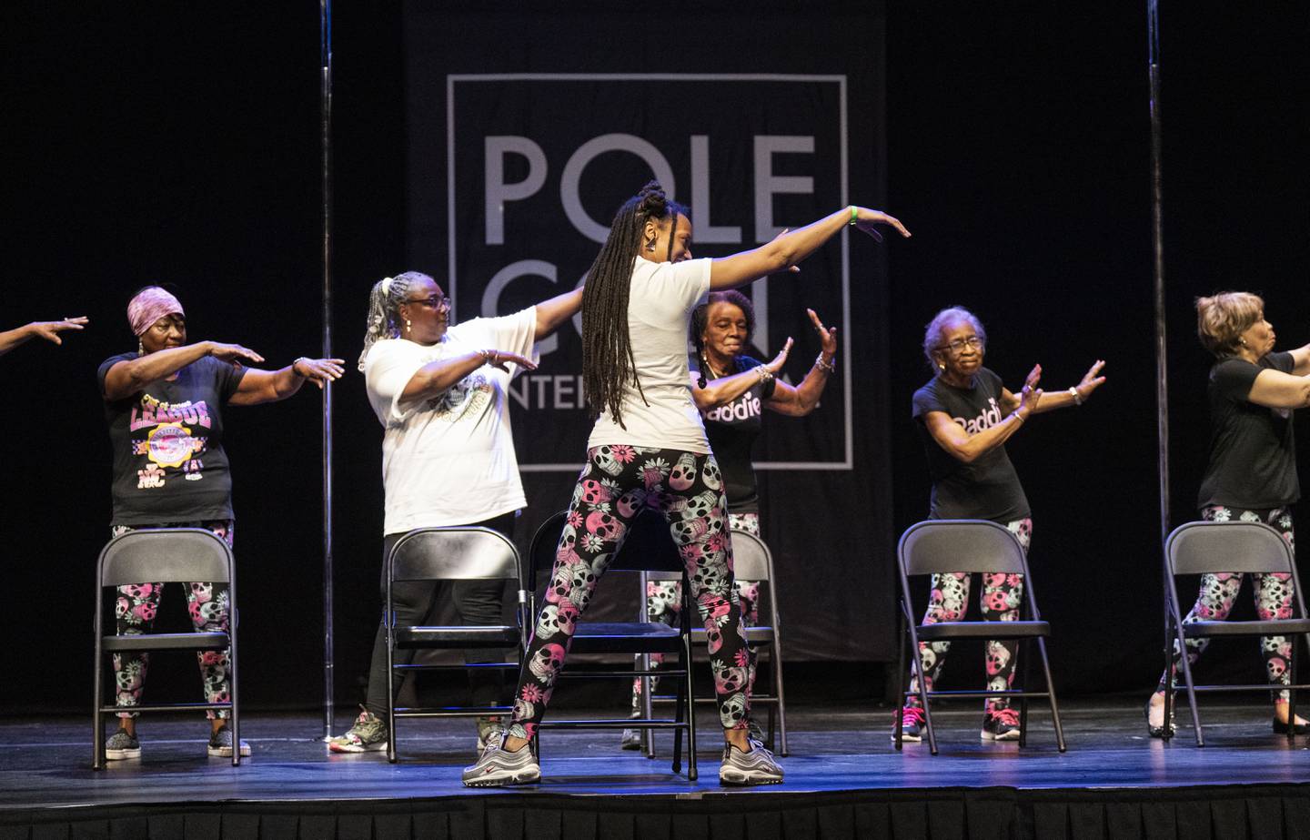 Mica Saunders, the founder of Moxie Moves, leads a chair dance with her group, Moxie Movez Grannies +1 Grandpa Dance Troupe, at PoleCon International, at Live! Casino & Hotel Maryland, Saturday, June 17, 2023.